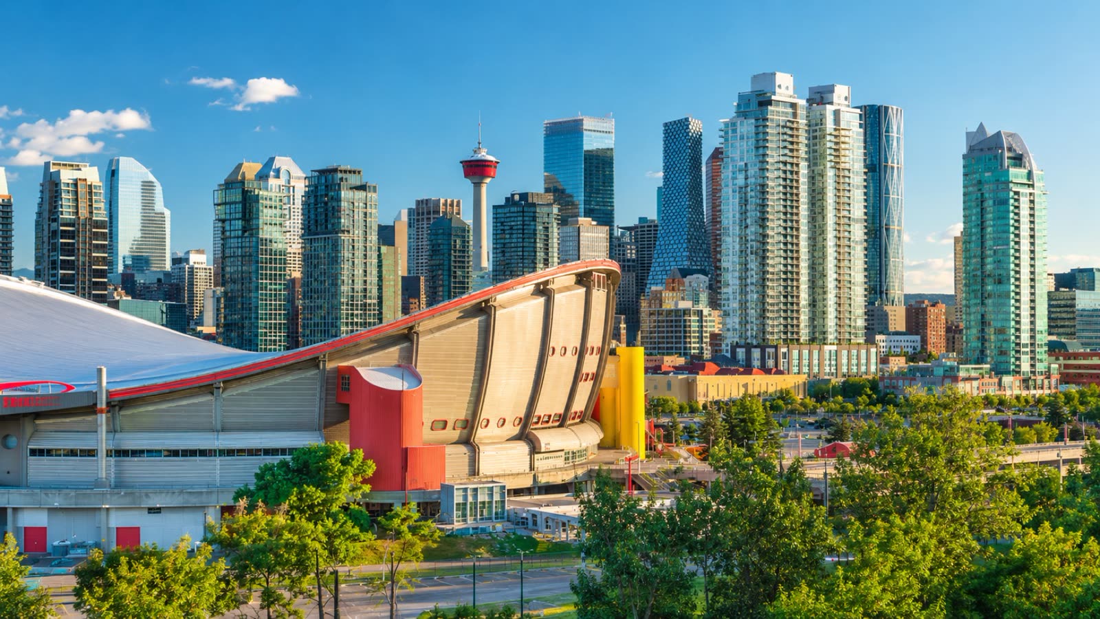 Downtown Calgary skyline with the Calgary Tower and the Scotiabank Saddledome on a clear summer day